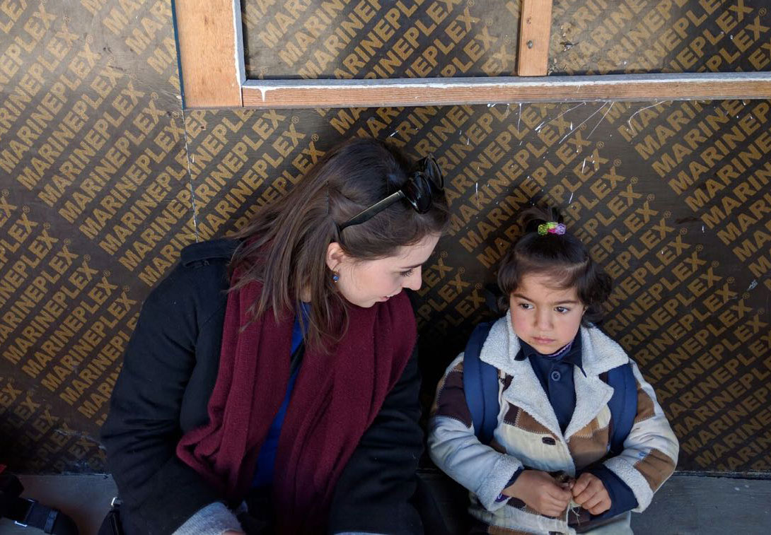 Margo Arsane with a Syrian child at a refugee camp in Lebanon